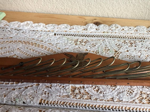 A Rustic Wood Wall Mount Tie Holder With An Eagle Design Attached And Twelve Metal Hangers See Description
