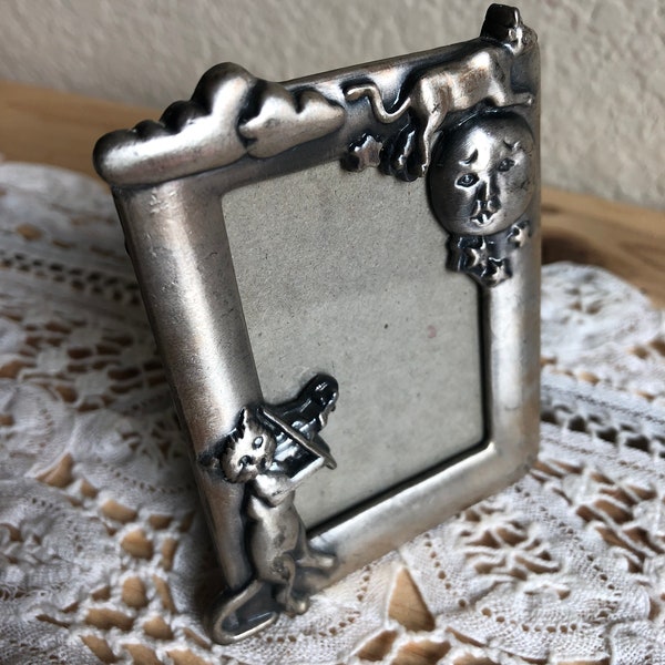 A Shabby Miniature/Small Silver Tone Decorative Metal Table Top Picture Frame With A Cat Playing A Fiddle And A Cow Jumping Over The Moon