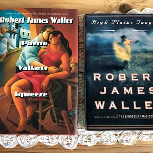 May include: Two books by Robert James Waller are displayed. The first book, "Puerto Vallarta Squeeze," features a couple in a romantic embrace. The second book, "High Plains Tango," has a woman dancing in a field. Both books are novels.