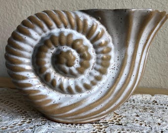 A Ceramic Textured Vase In The Shape Of A Shell See Description
