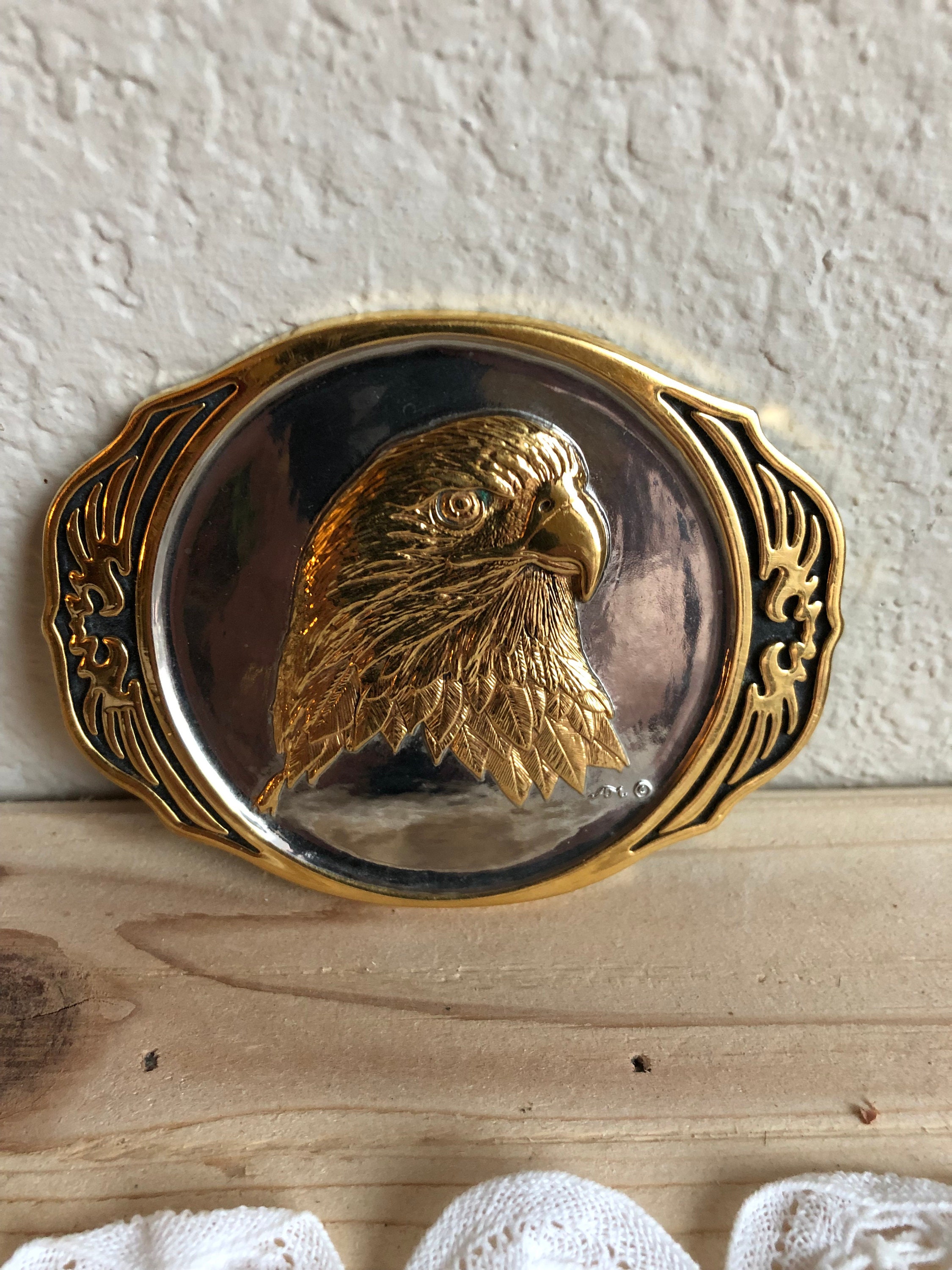 A Decorative Two Tone Metal Belt Buckle With the Head of an Eagle