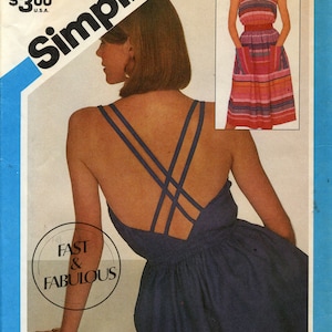 May include: A sewing pattern for a blue sleeveless dress with a criss-cross back detail. The pattern is Simplicity 6391, size N (10, 12, and 14).
