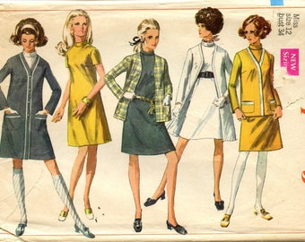 May include: A vintage sewing pattern for four different dress styles. The pattern is for sizes 12 and 34 bust. The dresses are in various colors, including yellow, blue, white, and green.