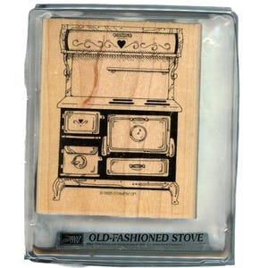 May include: Wooden stamp of an old-fashioned stove with decorative details, including a heart and scrollwork. The stamp is in a clear plastic case. The text "OLD-FASHIONED STOVE" is visible at the bottom.