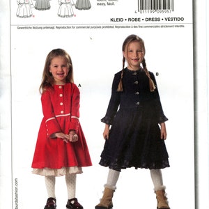 May include: A Burda sewing pattern for a dress with two different styles. The pattern number is 9595. The pattern is for sizes 92 to 128. The text on the pattern says "leicht, facile, easy, fácil." and "KLEID. ROBE. DRESS. VESTIDO".