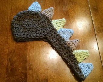 Baby/infant/newborn Dinosaur Crochet Hat with Tail and Spikes (Photo Prop). Brown dino hat with tail with blue, tan and green spikes.