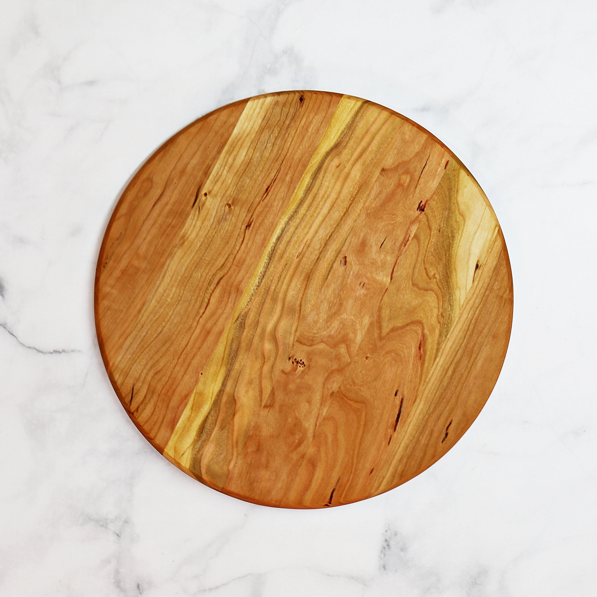 large circular wooden cutting board