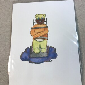 May include: A watercolor painting of a green teddy bear wearing a brown mask and an orange straitjacket. The bear is sitting in a chair on a blue cloud. The artist's signature, "Reyes", is in the bottom right corner.
