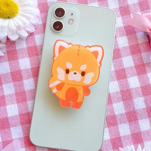 May include: A light green phone case with a red panda phone grip. The phone grip is a cartoon red panda with orange fur and a white face.