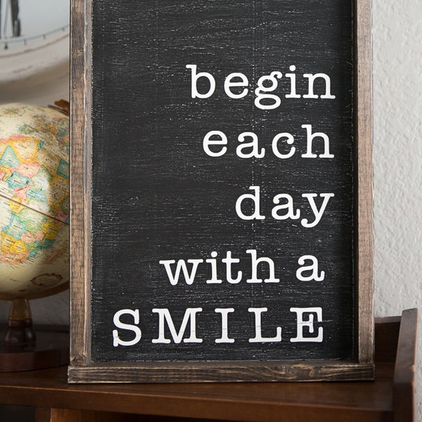 begin each day with a smile. 19.5 x 14 distressed wood sign. black with white writing.