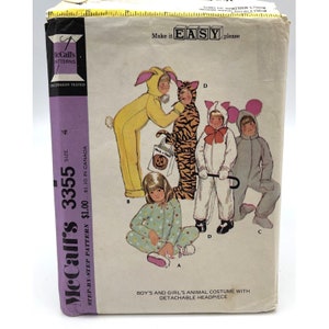 May include: Vintage McCall's sewing pattern for a boy's and girl's animal costume with detachable headpiece. The pattern includes a bunny, tiger, bear, and mouse costume. The pattern is labeled "Make it Easy" and "Step-by-Step Pattern".