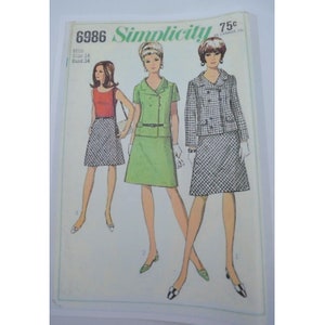 May include: Vintage Simplicity sewing pattern 6986 featuring three women's fashion designs. The cover shows illustrations of a red top and checkered skirt, a green suit, and a checkered jacket and skirt. The price is 75¢ in Canada.