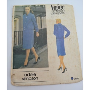 May include: A vintage Vogue American Designers sewing pattern for a blue skirt suit by Adele Simpson. The pattern number is 2656.