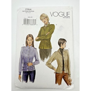 May include: A Vogue Patterns sewing pattern envelope labeled 7764, size 6, 8, 10. The front displays illustrations of three jacket styles: a lavender jacket with a belt, an olive green jacket, and a tan jacket, all featuring buttons and pockets.