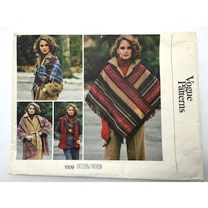 May include: A white ceramic mug with a black handle and the text "But First, Coffee" in a bold, black font. The mug is set against a blurred background, suggesting a cozy setting.