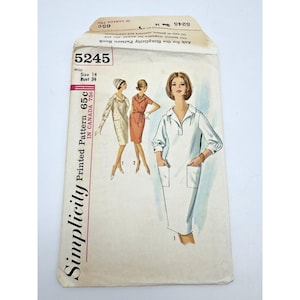 Può includere: Busta per cartamodello Simplicity vintage con illustrazioni di abiti. La busta è color crema e presenta il numero 5245 e il testo "Miss Taglia 14 Circonferenza seno 86 cm". Il logo Simplicity è visibile.