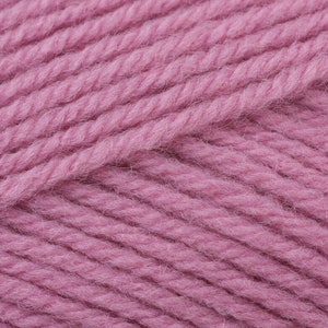 May include: Close-up of a soft, pink yarn. The yarn is made of wool and has a fuzzy texture.