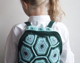 Crochet turtle childrens backpack with button fastening top in green.