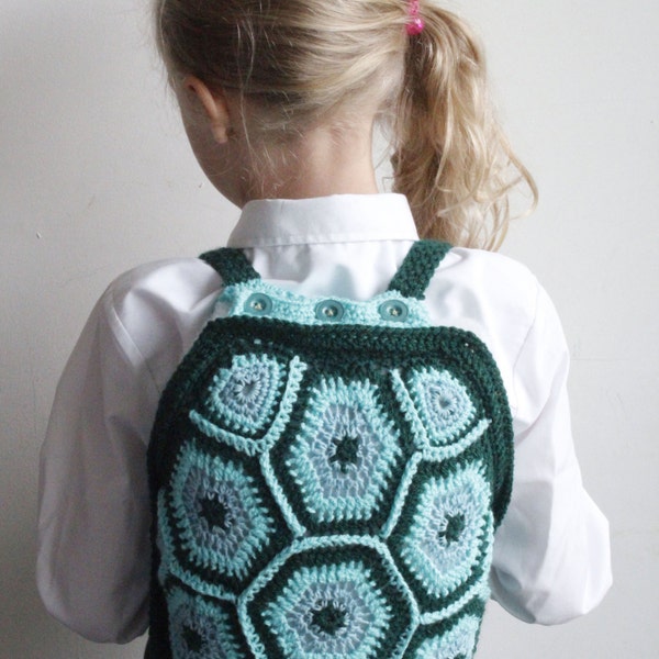 Crochet turtle childrens backpack with button fastening top in green.
