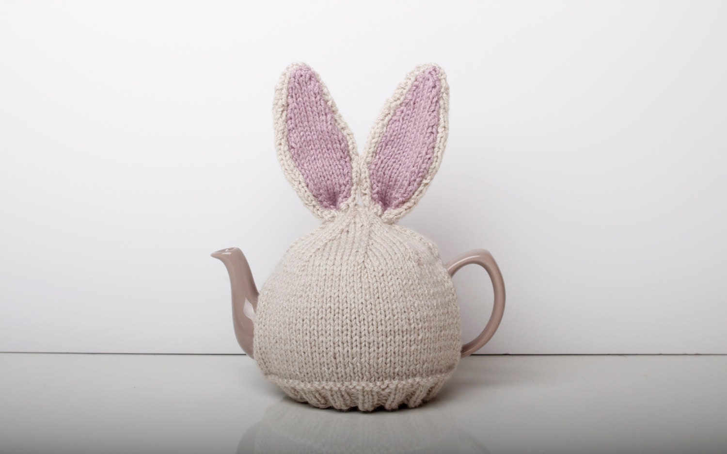 Hand knitted bunny rabbit tea cosy with pom pom bottom. Fits either 6…