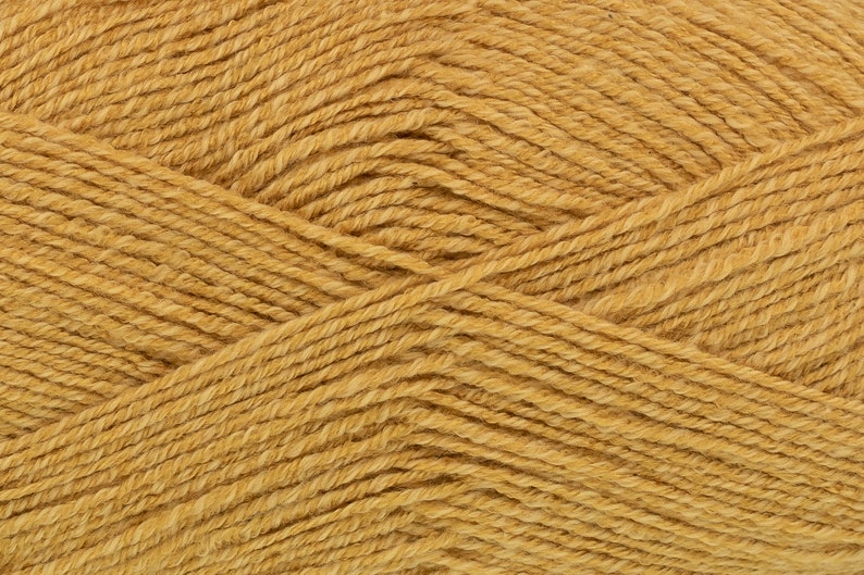 May include: Close-up of a skein of golden yellow yarn. The yarn is soft and fluffy, with a subtle sheen.