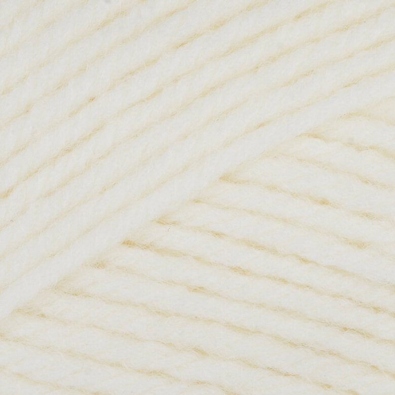 May include: Close-up of a skein of white yarn with a subtle beige sheen. The yarn is soft and fluffy, perfect for knitting or crocheting.