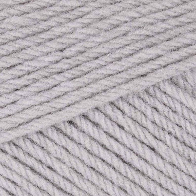 May include: A skein of light gray yarn with a soft, fuzzy texture.