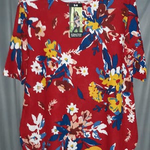 May include: A white ceramic mug with a black handle and the text "But First, Coffee" in a handwritten style. The mug is on a white surface. The mug is 4 inches tall.