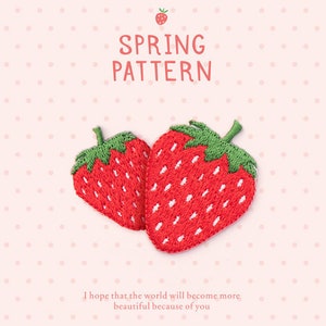 May include: Two embroidered strawberry patches with red bodies and green tops. The text "SPRING PATTERN" is above the strawberries, and the text "I hope that the world will become more beautiful because of you" is below.