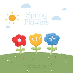May include: Embroidered patches with three vibrant flowers: red, yellow, and blue, with green stems and leaves, set on a green grassy hill. The text "Spring Flowers" is above the flowers, with a sun and clouds in the background.