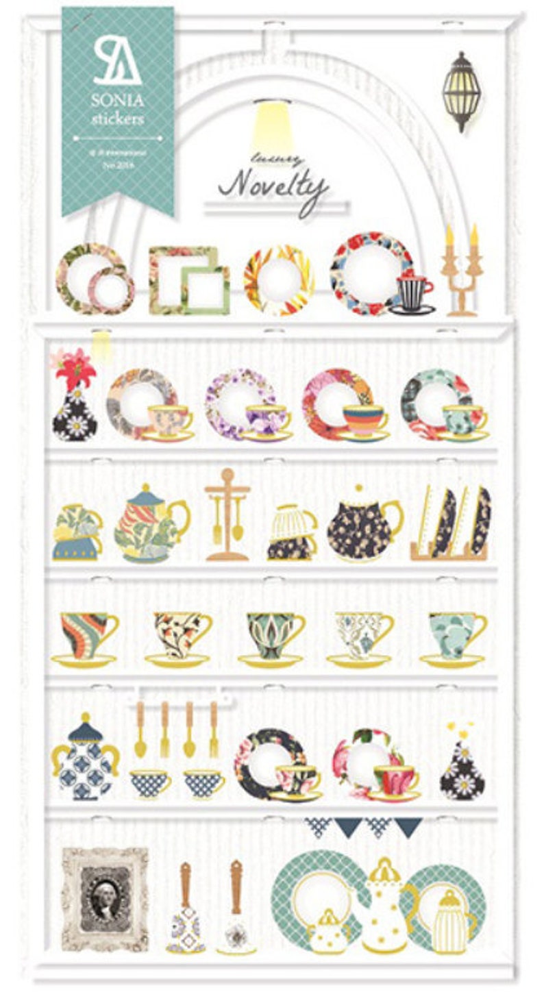 May include: A decorative sticker sheet featuring a variety of teacups, teapots, plates, and frames. The design includes floral patterns, geometric shapes, and the text "luxury novelty". The color palette includes blue, yellow, red, and green.