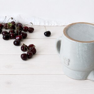 Rustic ceramic pitcher with farmhouse pottery character and rounded form