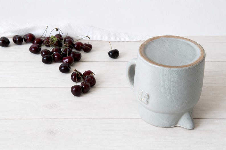 Rustic ceramic pitcher with farmhouse pottery character and rounded form