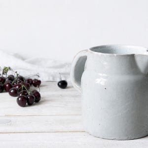 Rustic pottery vase with pale ceramic glaze and handcrafted character