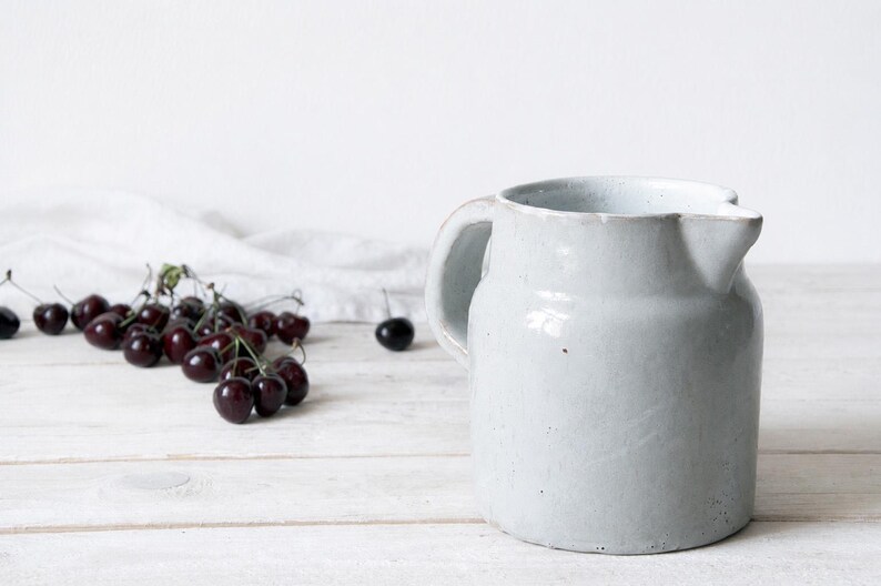 Rustic pottery vase with pale ceramic glaze and handcrafted character