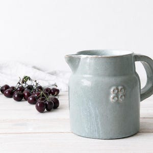Stoneware crock vase with pale glaze and traditional farmhouse shape
