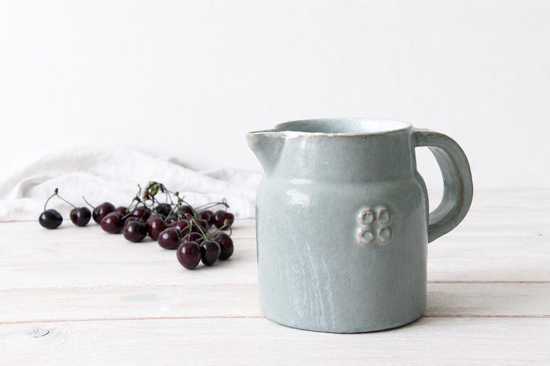 Stoneware crock vase with pale glaze and traditional farmhouse shape