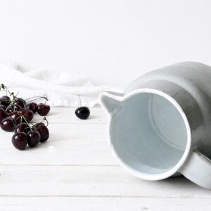 Handmade ceramic pitcher with natural speckled stoneware surface