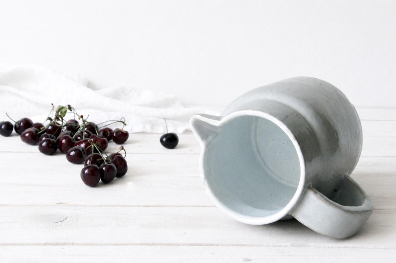 Handmade ceramic pitcher with natural speckled stoneware surface