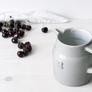 Vintage ceramic crock with sturdy handle and classic pottery form