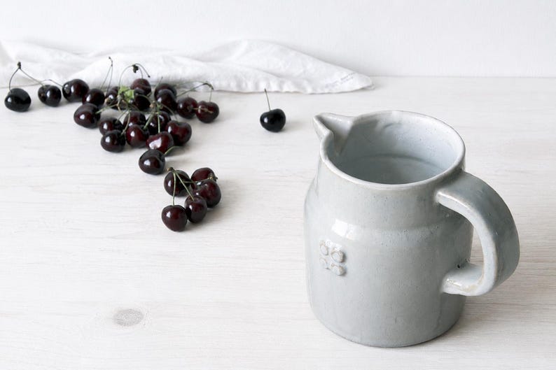 Vintage ceramic crock with sturdy handle and classic pottery form