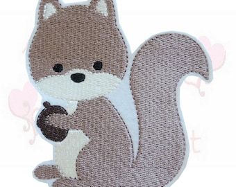 May include: Embroidered patch featuring a cartoon squirrel in shades of brown, beige, and white. The squirrel is holding a brown acorn. The patch has a detailed, textured appearance, with a white border.