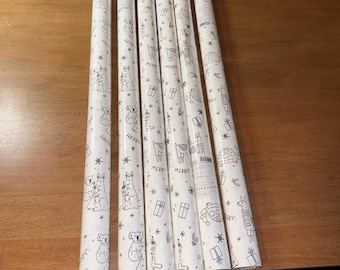 May include: Six rolls of white wrapping paper featuring a repeating black line art pattern of kangaroos, koalas, llamas, gift boxes, and snowflakes. The design includes the text Merry and Happy scattered throughout the paper surface.