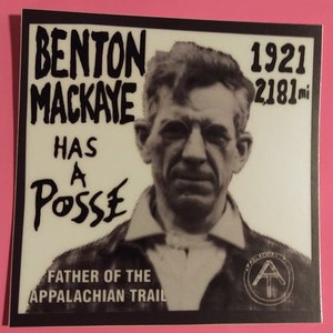 May include: Black and white photo of Benton MacKaye, the "Father of the Appalachian Trail", with the text "Benton MacKaye Has a Posse" and "1921 2181 mi" on a white background. The photo is surrounded by a black border.