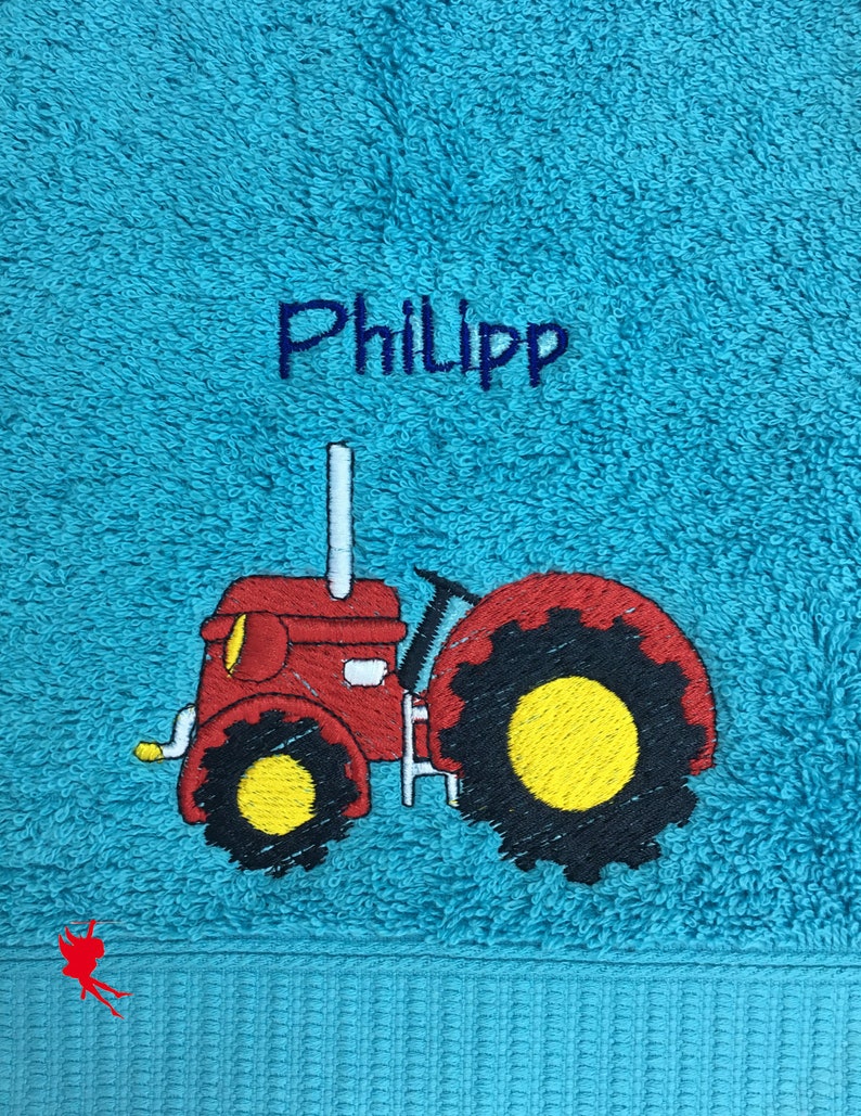 Serviette de tracteur brodée avec motif nom hellblau/türkisblau