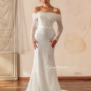 May include: A white off-the-shoulder wedding dress with long sleeves and a fitted silhouette. The dress is covered in sequins and has a satin sash at the waist. The dress is called "ERIN" and is designed by "Lace Marry".