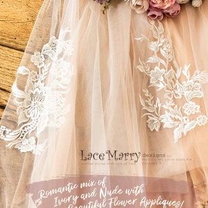 May include: A delicate ivory and nude tulle veil with lace appliques and floral embroidery. The veil is decorated with beautiful flower appliques. "Lace Marry designs by Mary Jin Mel & Gina Guang Hua Copyright &copy;"