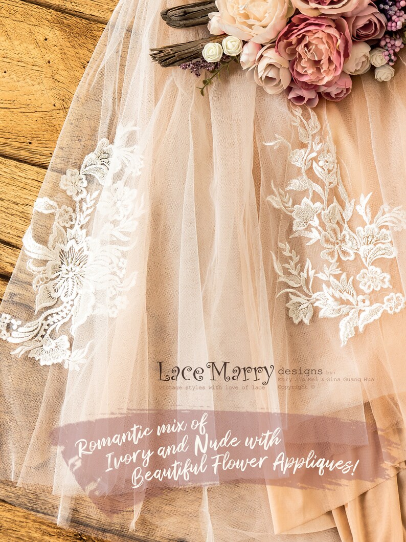May include: A delicate ivory and nude tulle veil with lace appliques and floral embroidery. The veil is decorated with beautiful flower appliques. "Lace Marry designs by Mary Jin Mel & Gina Guang Hua Copyright &copy;"