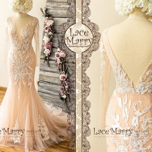 May include: A blush pink wedding dress with long sleeves and a deep V-neckline. The dress is made of lace and tulle and features delicate floral embroidery. The dress has a fitted bodice and a flowing skirt. The back of the dress has a low back with a V-shaped neckline. The dress is shown on a mannequin against a wooden background. "Lace Marry" designs is written on the bottom of the image.