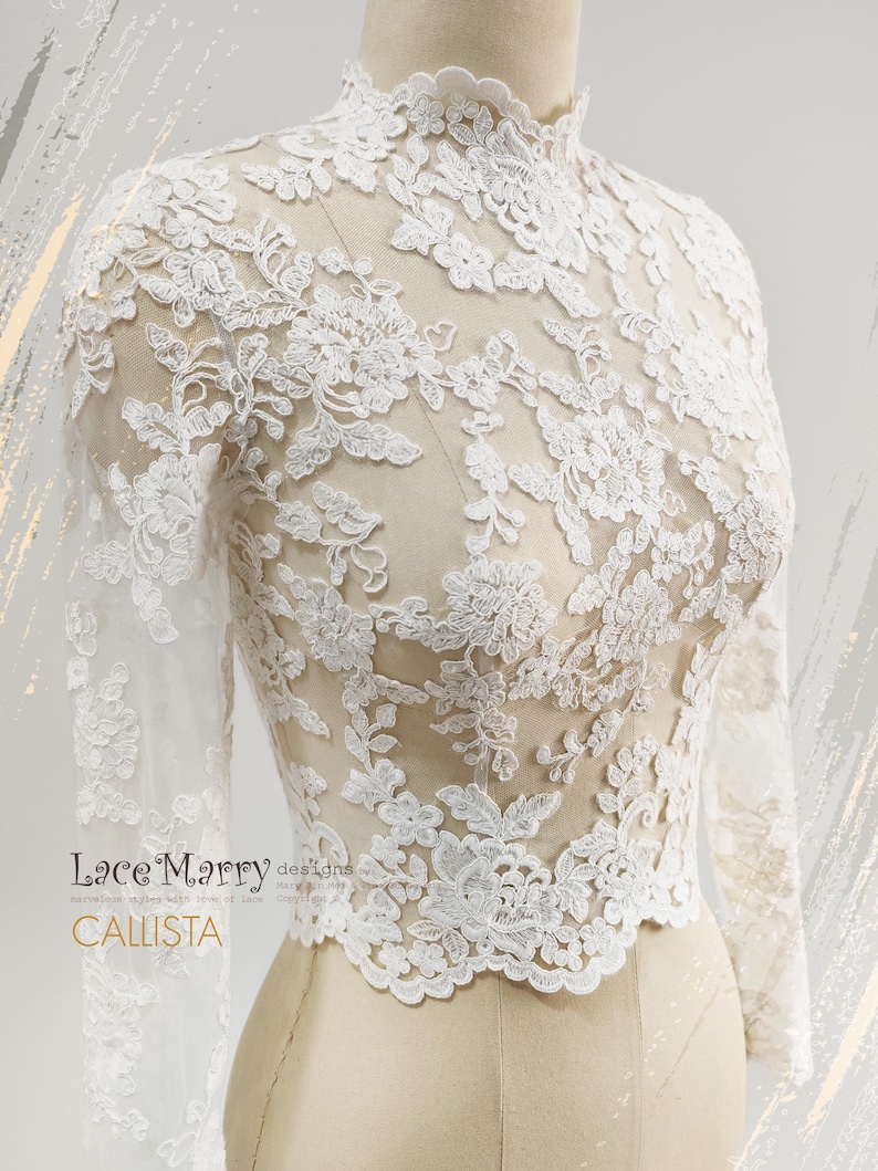 May include: A white lace top with long sleeves and a high neckline. The intricate floral lace design covers the entire top, creating a delicate and elegant look. The top is displayed on a mannequin, showcasing its form and details. The text "Lace Marry designs" and "CALLISTA" are visible.